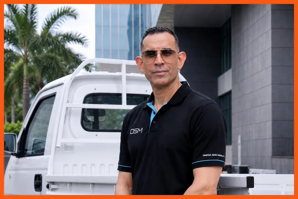 Dr Uday Narang, Founder and Chairman of Omega Seiki Mobility, beside an OSM electric cargo vehicle