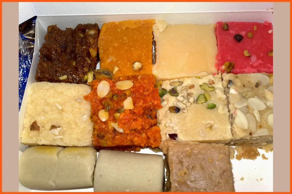 An open box of assorted burfi and other Indian sweets, a common Diwali gift