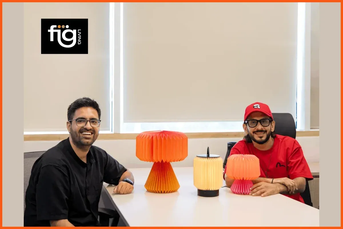 FIG Living co-founders with the brand's folded-paper table and portable lamps